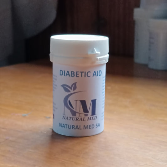 Container labeled 'Diabetic Aid' by 'Natural Med SA' on a wooden surface.