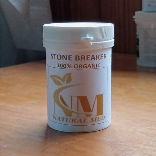 Container labeled 'Stone Breaker 100% Organic' by 'Natural Med' on a wooden surface.